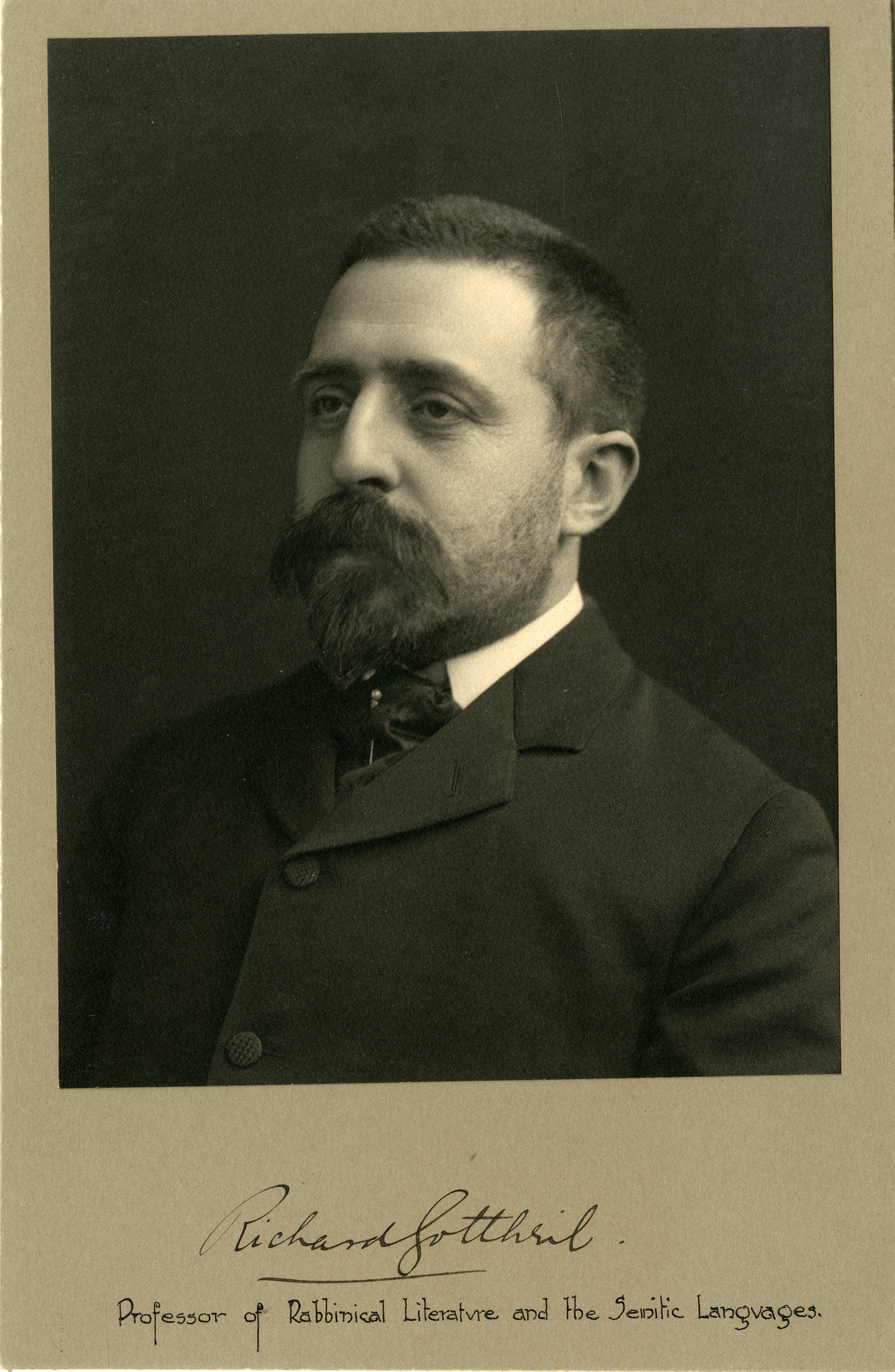 Man with beard and mustache, wearing a suit