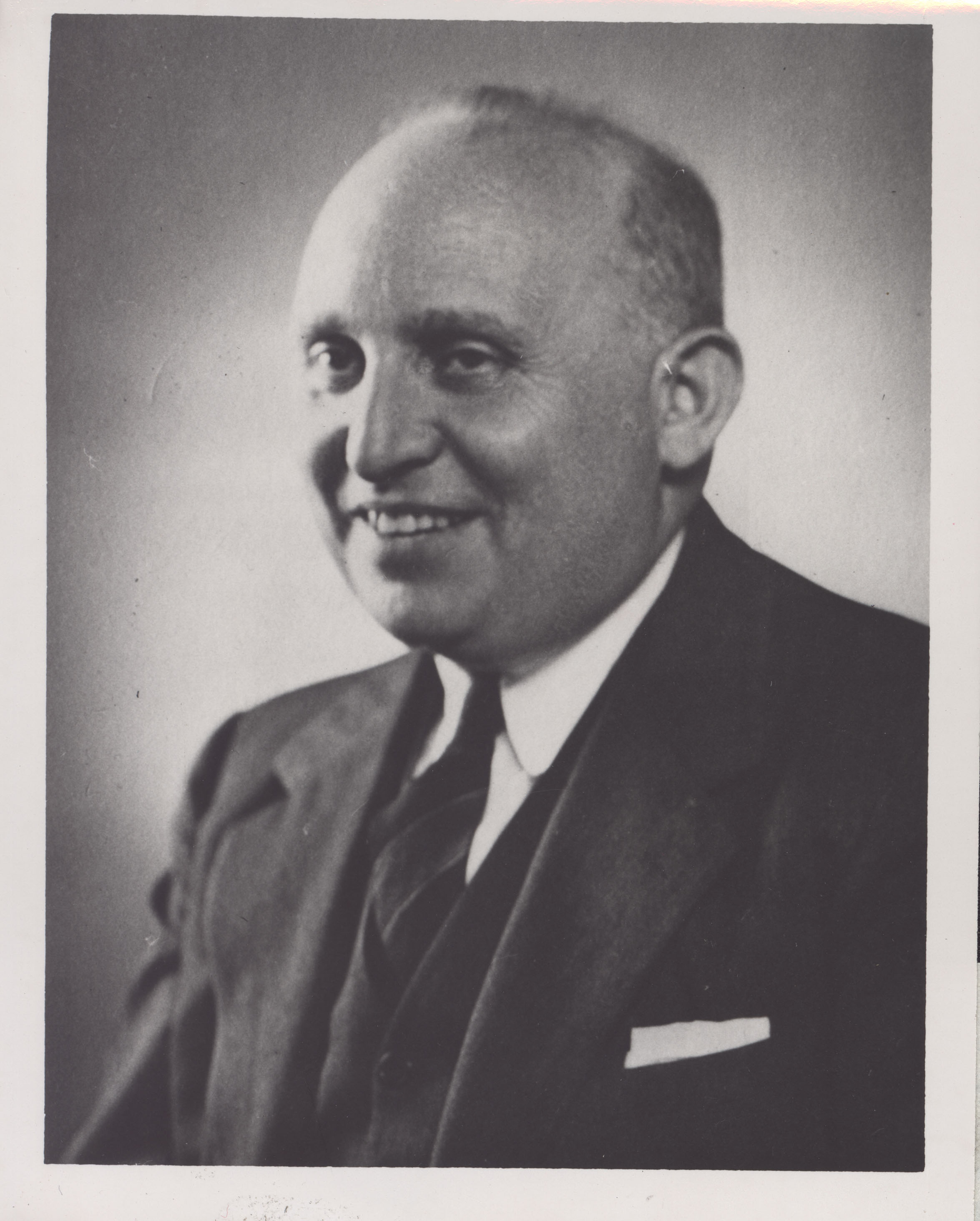 Image of a smiling, balding man