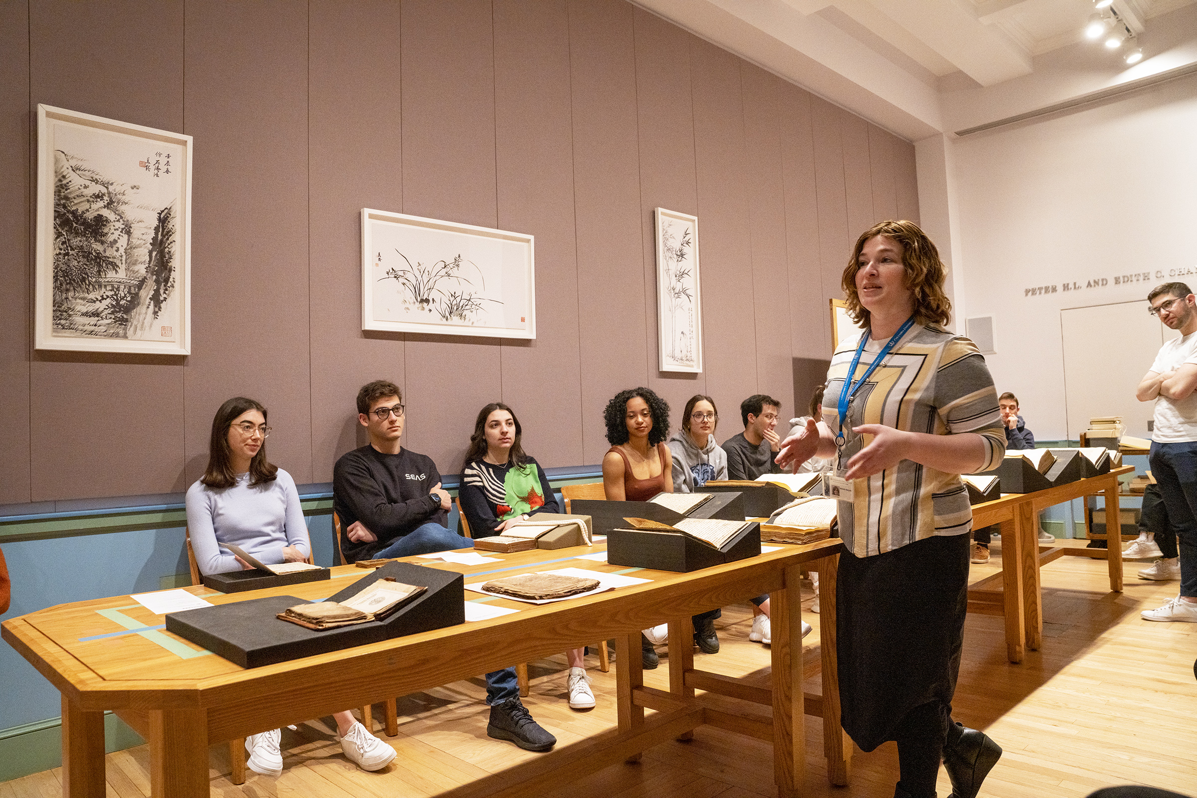students around a table with rare books and manuscripts